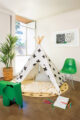 black and white fabric teepee in kids' playroom