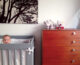 gray crib and walnut dresser in neutral nursery
