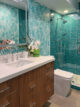 Palm Springs bathroom with teal tile and leaf wallpaper