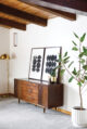 vintage mid century modern credenza matches the exposed wood beams in the ranch style ceiling
