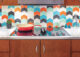 kitchen with MCM backsplash tile in orange, mint, turquoise, black and white