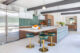 green barstools on long kitchen island in renovated Eichler home