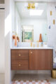 renovated Eichler bathroom with wood vanity and white tile with random geometric accents
