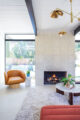 fireplace in open concept Eichler living room with view to backyard