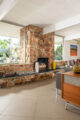 renovated MCM windows surrounding a stone fireplace in a Palm Springs home