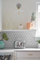 white MCM kitchen with linear tile vintage toaster and white vintage lighting sconce