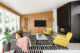 living room with fireplace and wood slat walls in 1960 Washington home