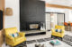 brick fireplace surround painted black with yellow armchairs in 1960 Washington home