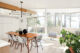 living room with wall of windows with hillside view in 1960 Washington home