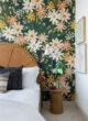 bedroom of rental apartment with floral peel and stick wallpaper
