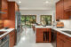 open concept kitchen dining and living room with terrazzo floors and teak cabinetry in MCM kitchen