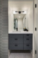 modern updated bathroom with gray tile and cabinetry