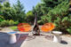 Oregon backyard with Acapulco chairs and mod freestanding fireplace