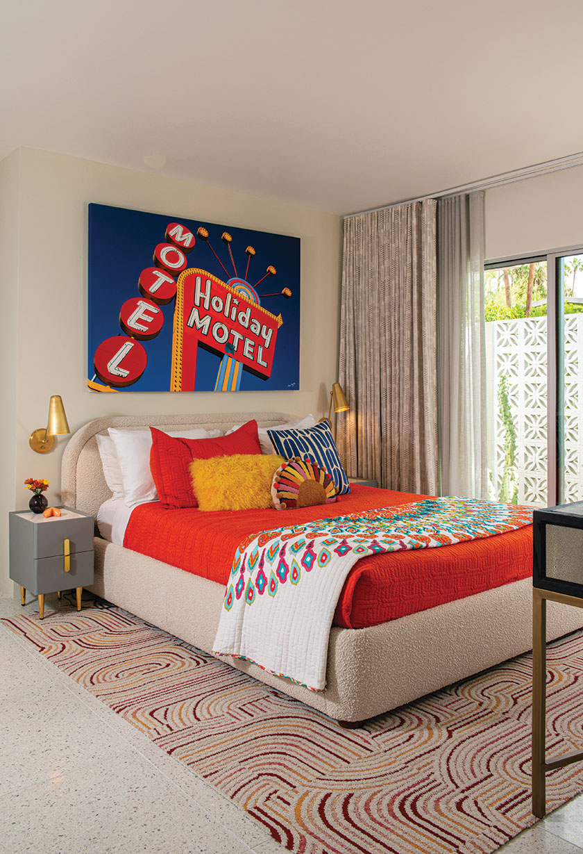 retro motel sign art print as focal point in bedroom of renovated 1957 Du Bois house