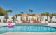 Palm Springs backyard with orange lounge chairs and pool