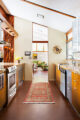 Riverside galley kitchen with runner rug and over counter lighting