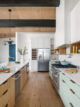 galley kitchen with mint cabinetry and vertical storage