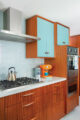 wood and turquoise cabinetry in galley kitchen