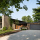 mid century Indiana home with natural elements such as stone and wood siding as well as architectural lines to create curb appeal