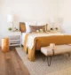 mustard colored bedding in primary bedroom of 1959 Rossmoor home