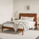 a wooden bed with slatted headboard