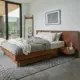 a modern bed with built-in headboard that includes nightstands. 
