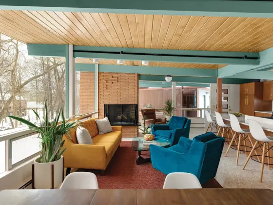 living room with a view and fireplace in renovated mid century home