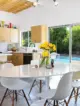 a mid century modern kitchen in palms springs with a view of the pool outside the sliding glass doors