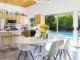 a mid century modern kitchen in palms springs with a view of the pool outside the sliding glass doors