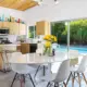 a mid century modern kitchen in palms springs with a view of the pool outside the sliding glass doors
