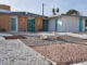 the exterior front view of a mid century modern home in las vegas with xeriscaping