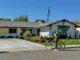 woman on a bike in front of a mid century ranch style house in las Vegas