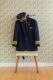 a pilot's uniform hanging on the coat rack