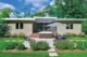 the back view of a mid century modern house with a modern patio set and an umbrella to the right and mid-century modern landscaping 