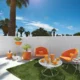 two homecrest swivel chairs with bright orange upholstery