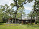 a mid century modern house in chicago set into tall trees