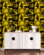 A white and black retro side table with a black and yellow wallpaper featuring women’s faces with retro style.