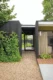 A Boise Mid Century Modern home with wood clad exterior walls painted black. 
