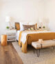 mustard colored bedding in primary bedroom of 1959 Rossmoor home