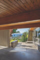 car port of a mid century modern home in Boise with wood cladding above and stonework sides